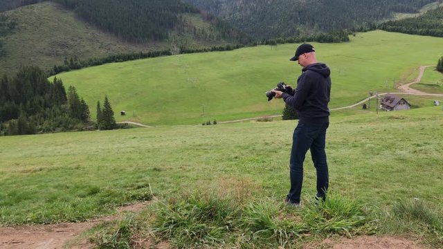 Male photographer taking pictures   Mountains. Ski resort, Tatra Mountains, Slovakia