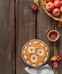 homemade apple pie on a wooden rustic background, top view