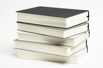 A Disarrayed Stack OF Monochromatic Cloth Bound Books Set On  White Background