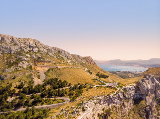 Aerial view of Mirador Es Colomer viewpoint, Cap De Formentor, Mallorca. Known as meeting point of the winds. Very popular tourist destination. Port de Pollenca on background.