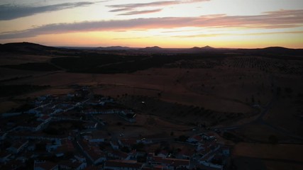 Aerial view from an amazing sunset in Alentejo, Portugal. With agricultural fields in background.