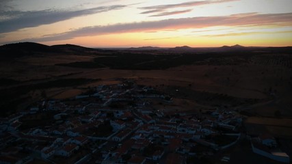 Aerial view from an amazing sunset in Alentejo, Portugal. With agricultural fields in background.
