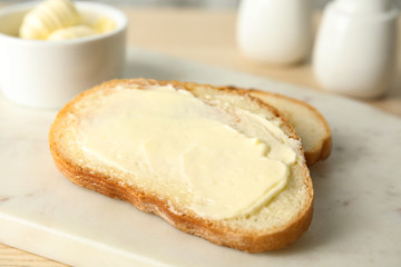 Fototapeta na wymiar Tasty bread with butter for breakfast on marble board