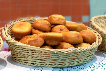 fried pies in a wicker basket on the counter in the bakery in the supermarket