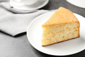 Piece of delicious fresh homemade cake on grey table