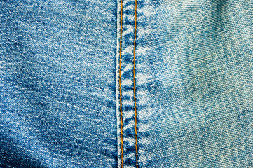 clothing items blue stonewashed faded jeans cotton fabric texture with seams, clasps, buttons and...