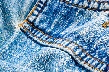 clothing items blue stonewashed faded jeans cotton fabric texture with seams, clasps, buttons and...