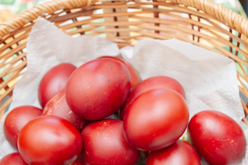 Painted eggs in onion peel lay in the wicker basket