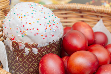 Easter spring cake with painted chicken eggs in a wicker basket