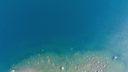 Fototapeta na wymiar Aerial view of the deep blue lake and the rock