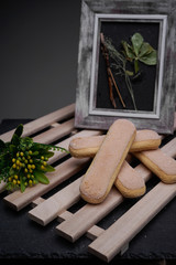Ladyfinger biscuits for a Classic tiramisu dessert and a glass cup of coffee for dipping