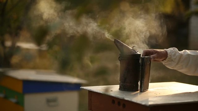 bee-maker of a smoke pipe beeper smoker device for repelling evil bees.