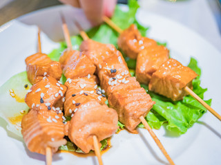 Typical Japanese dish of salmon just seared in soy sauce, over a bed of lettuce.