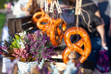 Sweet bagels weigh on a rope. Dessert in sunny lighting. Baking on a trading tray. Bagel baked in the oven.