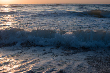 Sunset or dawn on the sea, waves and the sun.