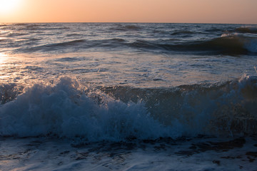Sunset or dawn on the sea, waves and the sun.