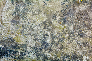 Texture of rough concrete or cement surface with stains of black paint and dirt