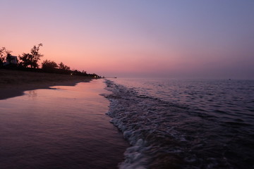 perspective straight coastline under sunset purple sky. Low angle. In Haikou Hainan China 