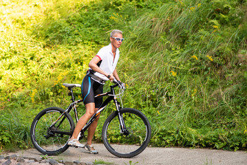 Obraz premium Woman in sportswear on a bicycle.