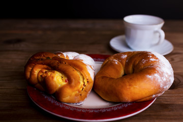 Sweet donut and cup of tea on a wooden table