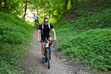 Fototapeta premium A man on a bicycle descends from the mountain.