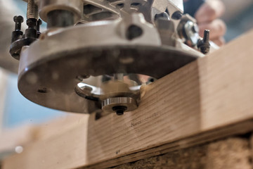 Using electric woodworking. High speed process of cutting, trimming close up view