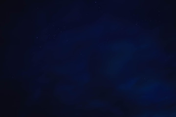 blue starry sky through gray clouds