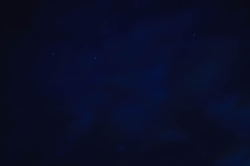 blue starry sky through gray clouds