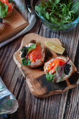 sandwiches with red, black caviar and trout .submitted on wooden planks