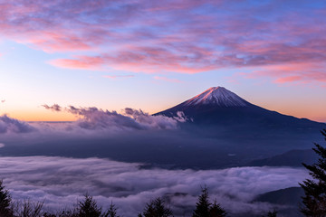 Fuji mountain and the mist over Lake Kawaguchiko at beautiful sunrise , Yamanashi, Japan, Mount Fuji or Fujisan located on Honshu Island, is the highest mountain in Japan. - obrazy, fototapety, plakaty