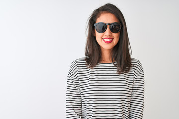 Chinese woman wearing striped t-shirt and sunglasses standing over isolated white background with a happy and cool smile on face. Lucky person.