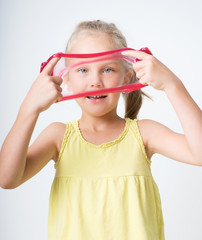 Happy joyful girl playing a red slime