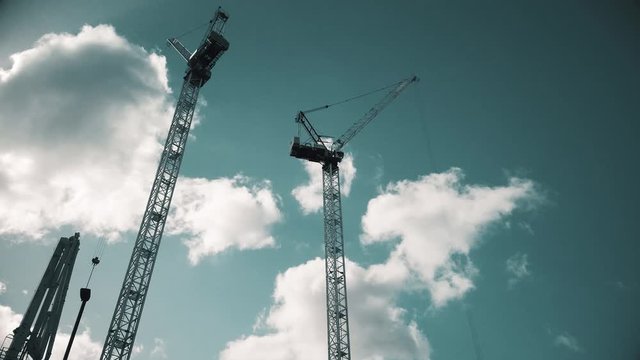 Crane are working on building constraction on blue sky background