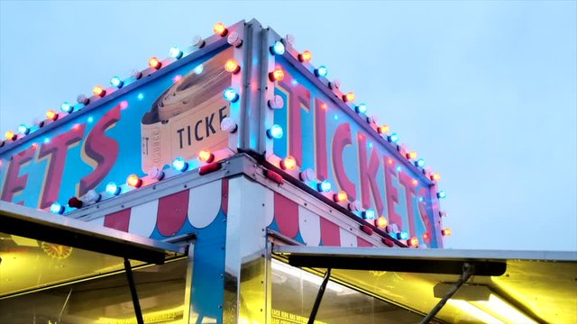 Static shot of ticket truck with blinking Ticket sign at carnival