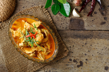 Panaeng Curry with chicken breast in bowl glass on wood background