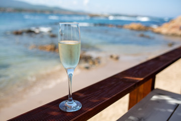 glass of white wine on the beach