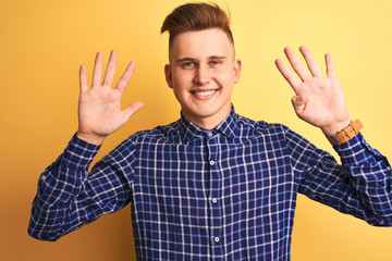 Young handsome man wearing casual shirt standing over isolated yellow background showing and...