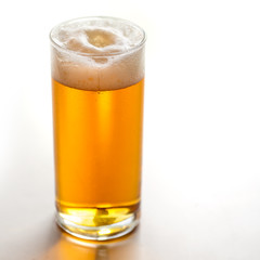 Glass with beer on a white background.
