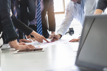 Close up shot business people team meeting in conference room in company. Businessman pointing pen at document on the table.