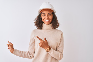 Young brazilian architect woman wearing security helmet over isolated white background smiling and...