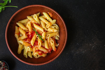 pasta penne and tomato sauce - delicious second course, menu concept. food background. copy space