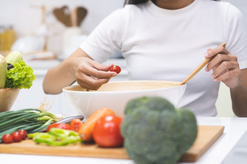 Obraz na płótnie Canvas Eat healthy food for good wellness health concept. Woman cooking salad menu with fresh organic vegetables