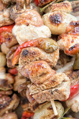 Cooked skewers of meat and vegetables background