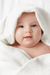 Smiling baby in a towel