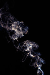 Abstract white smoke swirls on black background