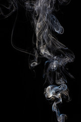 Abstract white smoke swirls on black background