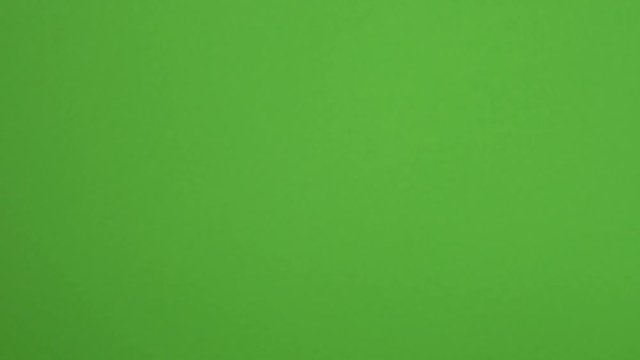 Closeup view of beautiful female hands with trendy modern stylish two colours manicure opens empty palm as if showing something virtual and invisible isolated on green background. 4k video footage. 