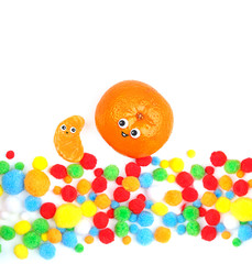 creative celebration concept. Funny food - tangerines couple. tangerine and tangerine slice. minimalism style. Orange citrus with smile and festive confetti on white background, concept of birthday