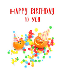 Obraz premium Happy birthday to You. greeting card with two funny oranges in festive hat. creative idea of cheerful fresh fruit. funny fruit. Tangerines with smile and colorful confetti on white background.