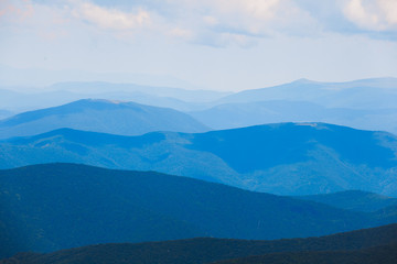 Mountain landscape of blue hills on the background of cloudy sky